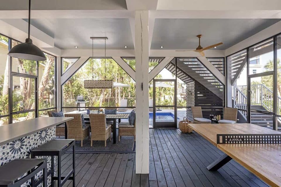 Discover outdoor living at its finest!  Just off the pool, there is a large screened great room with group dining, pool bar, games, and cozy seating.  Relax and entertain in this remarkable outdoor oasis.