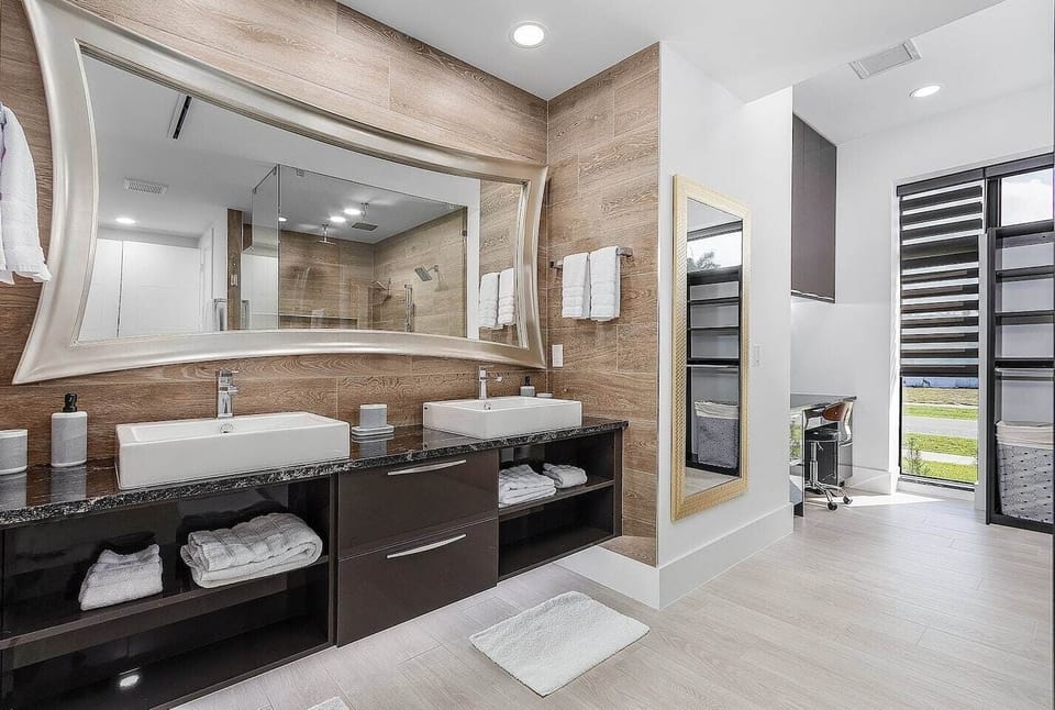 Master Bathroom: Dual vanity sinks and entrance of walk-in closet w/work station/desk