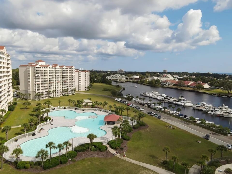 Resort aerial with sparkling pools and palms