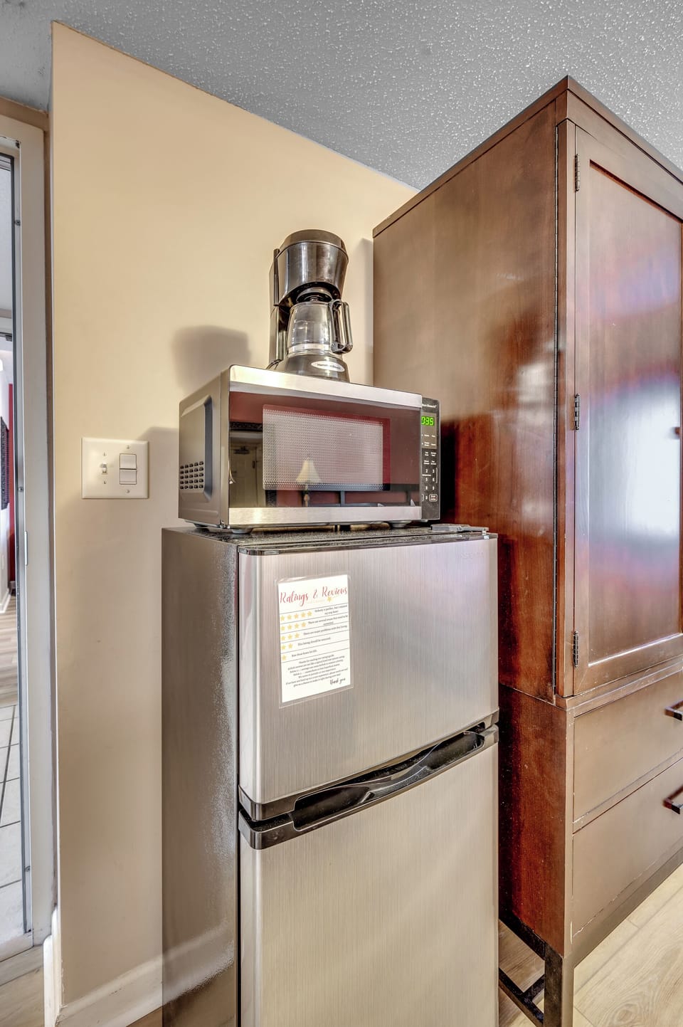 Sleek fridge and microwave in compact space
