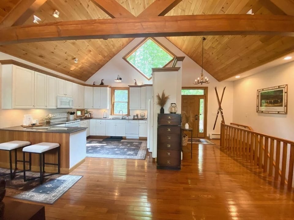 The open kitchen area, with the entry foyer and stairs to the lower level!