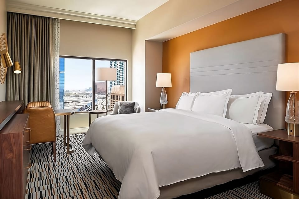 Wake up to skyline views from crisp, cloud-like bedding.