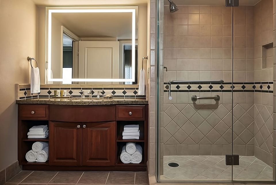 Refresh easily in a spacious bath with bright, modern lighting.