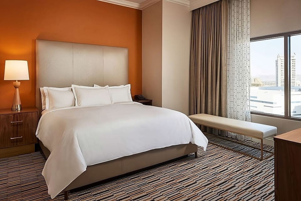 Stretch out in a serene room with bright city vistas.