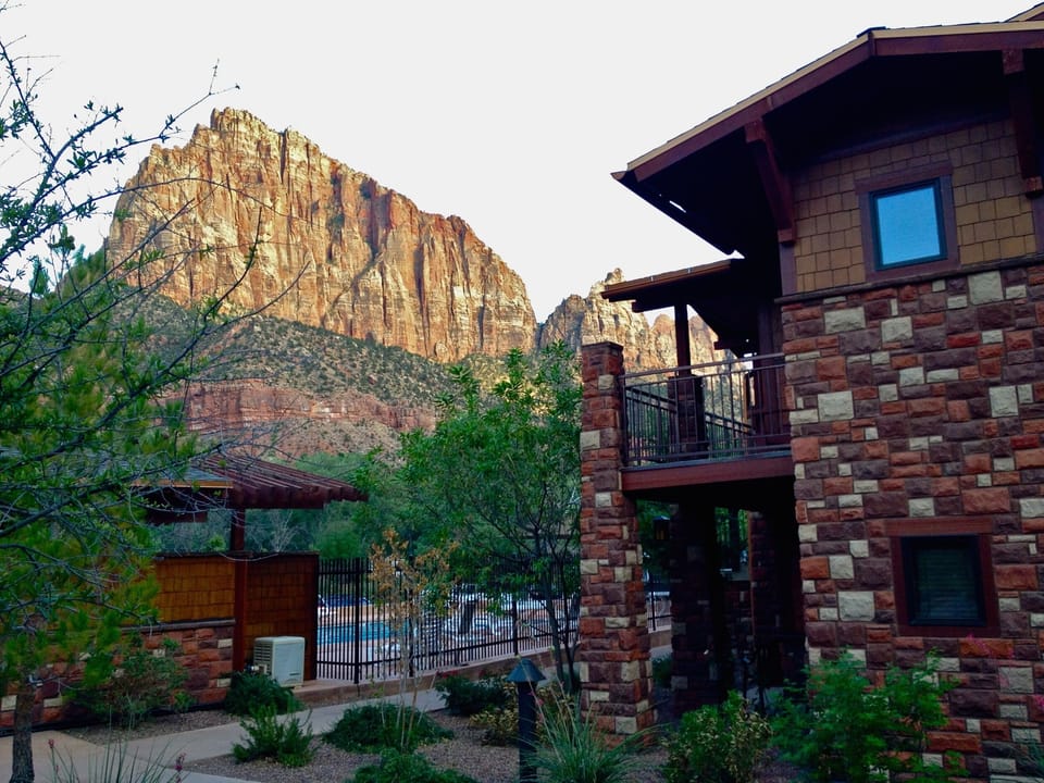 Step outside to epic mountain views beside lodge-style buildings.