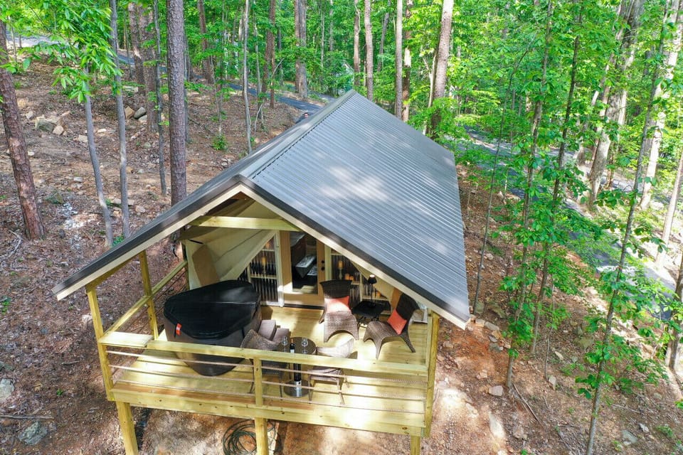 Experience the outdoors in style with this glamping tent, complete with a large covered deck. Perfect for a peaceful retreat or an adventurous getaway.