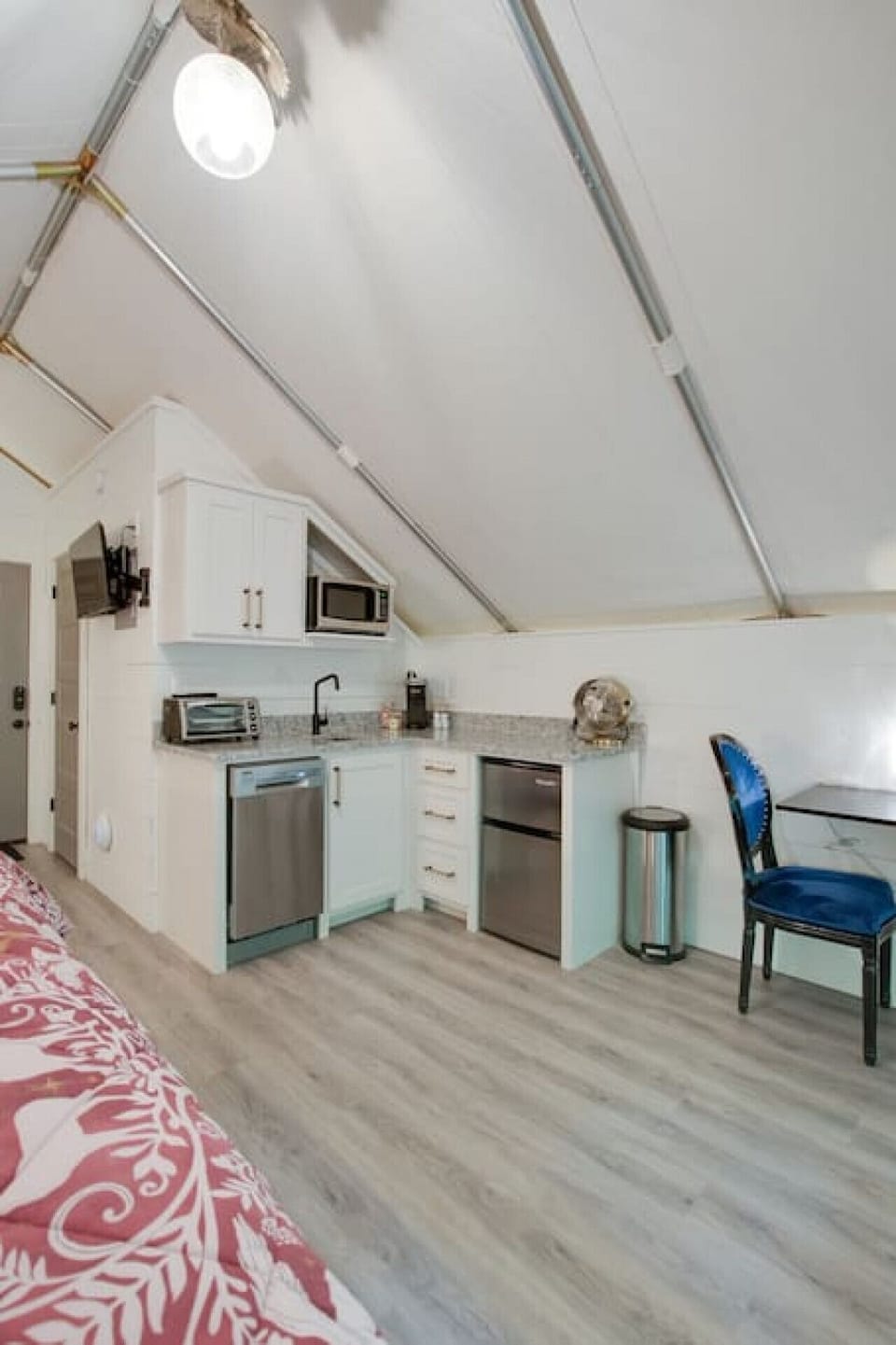 Spacious glamping tent with a complete kitchenette including a dishwasher and modern appliances, paired with a tasteful decor for a unique and enjoyable getaway