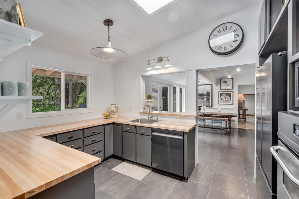 Kitchen with view into additional dining and large family room