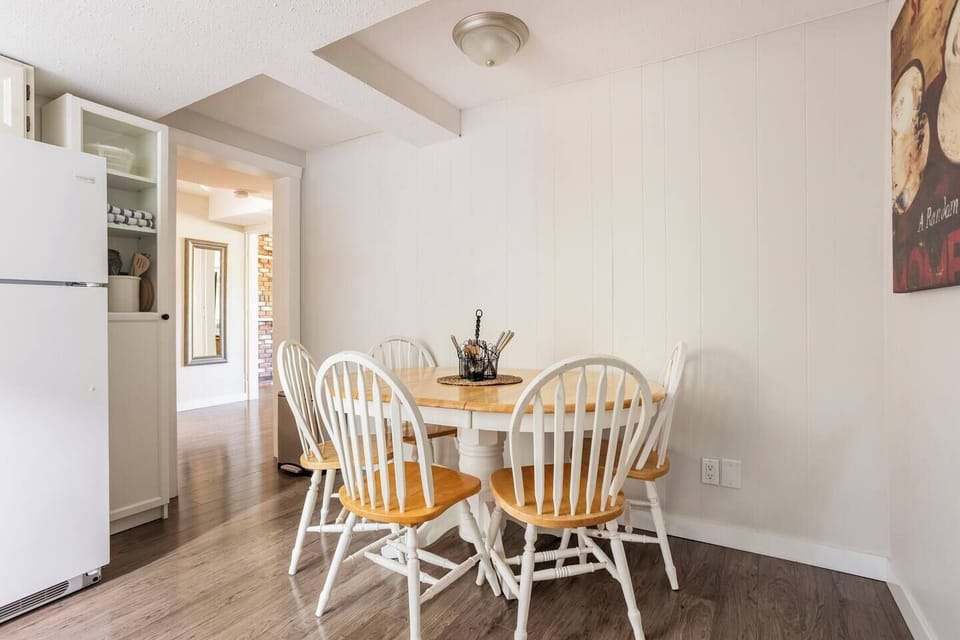 The spacious dining room is typically set up with seating for 4, but a 5th chair is available.