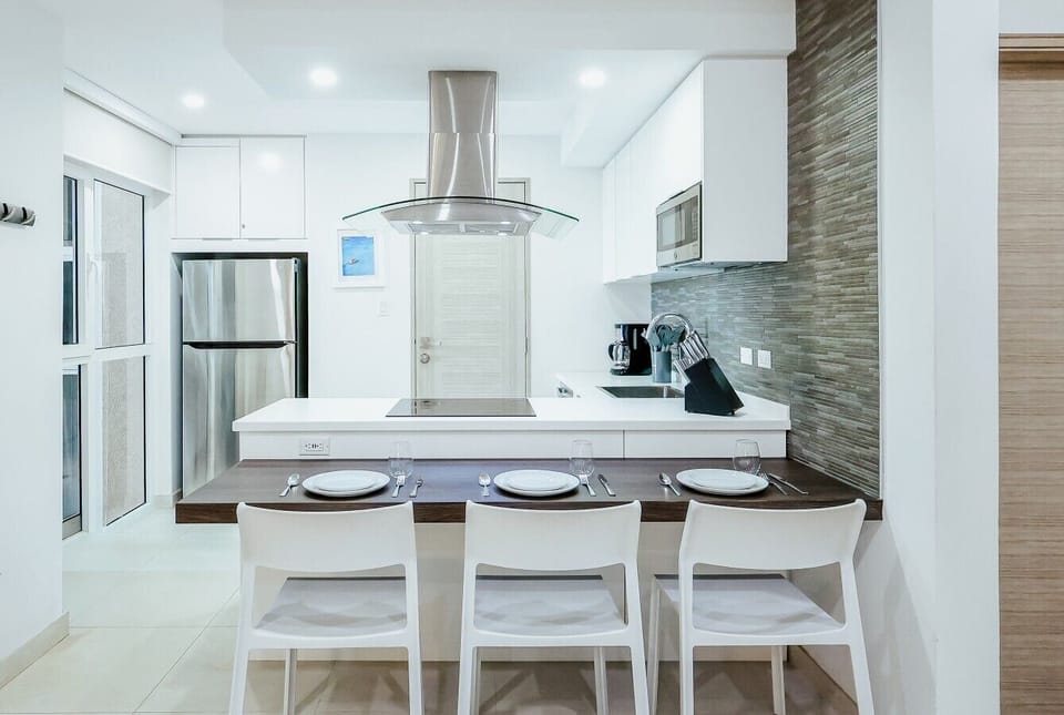 Fully equipped kitchen featuring modern appliances, cookware, essentials, and ample space for meal preparation.