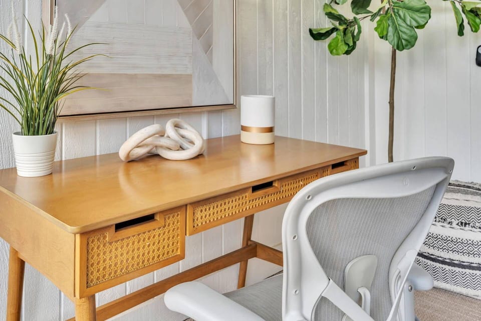 A minimalist, modern workspace with a wooden desk and a stylish office chair. Perfect for productivity!