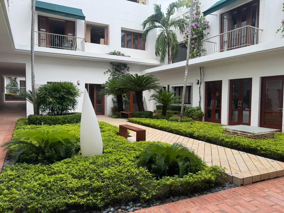 Lush green areas and palm trees create a relaxing vibe
