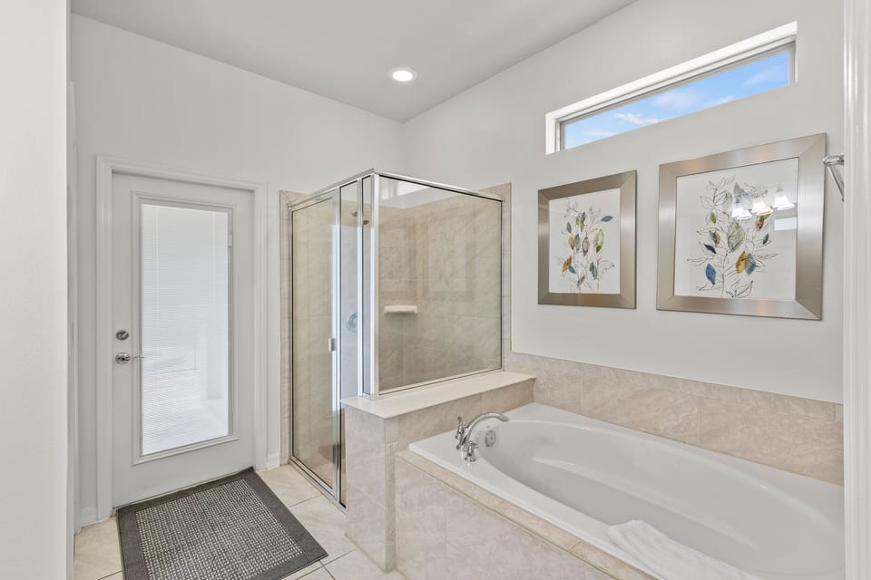Master bedroom en-suite bath and exit to swimming pool