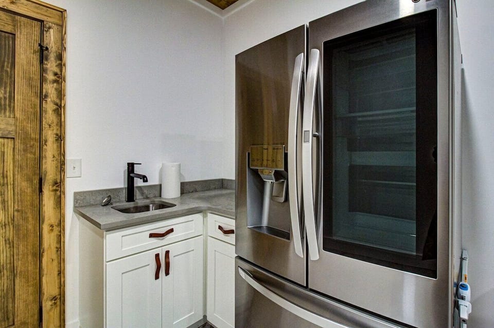 A small kitchenette is located off of the game room/bunk room with a large full size fridge