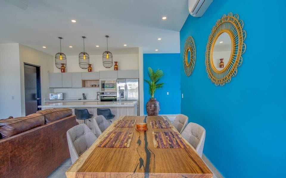 The dining table seats 6 plus room for 3 more at the breakfast bar.