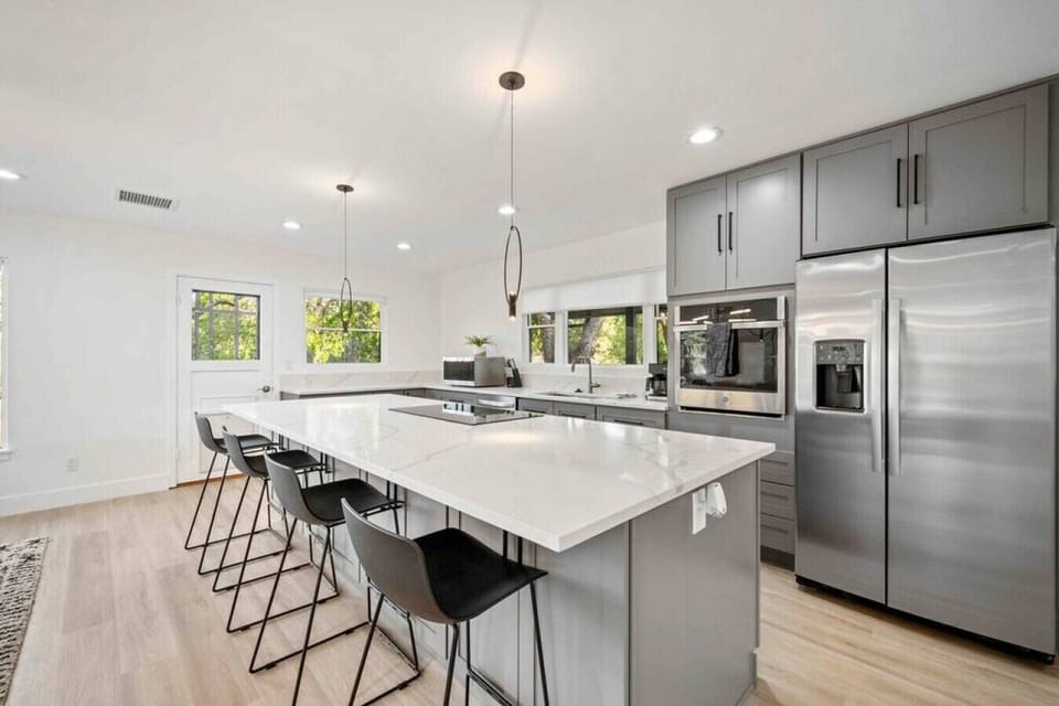 The modern and updated kitchen has barstool seating for four