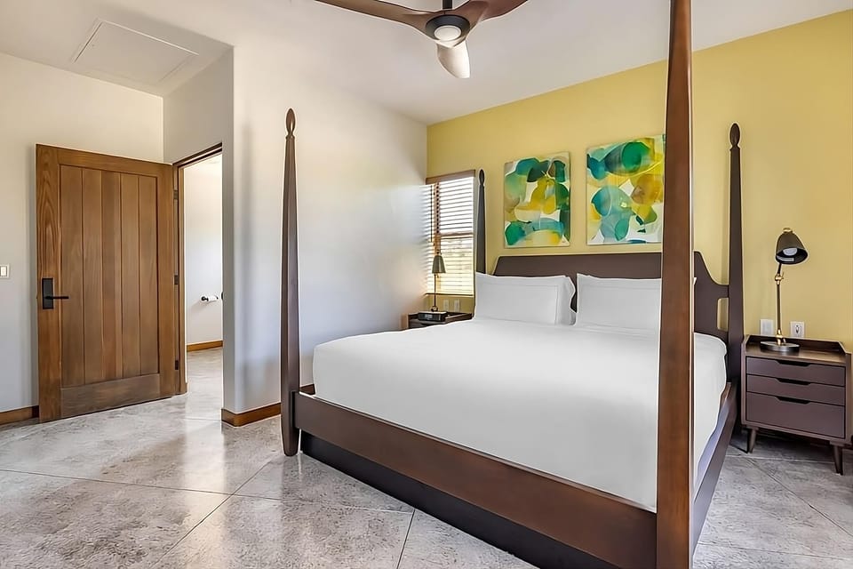 Unwind in a luxe four-poster bed with airy, modern calm.