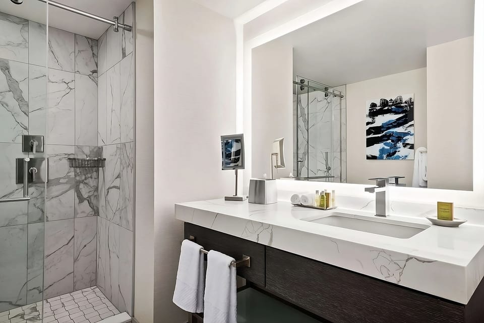 Refresh in a spa-like marble bath with glass shower.