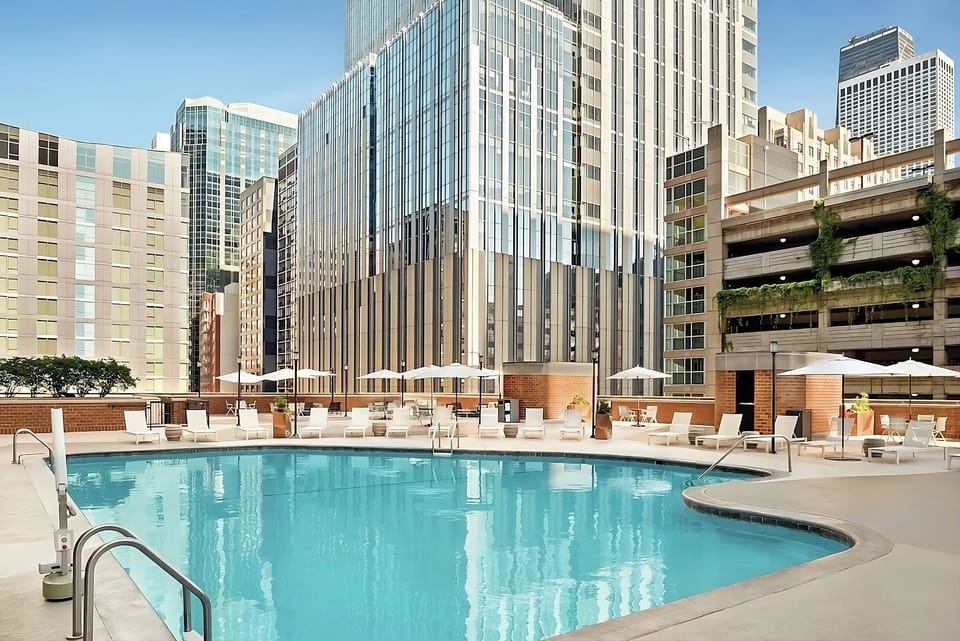 Dive into sunlit rooftop serenity with skyline reflections.