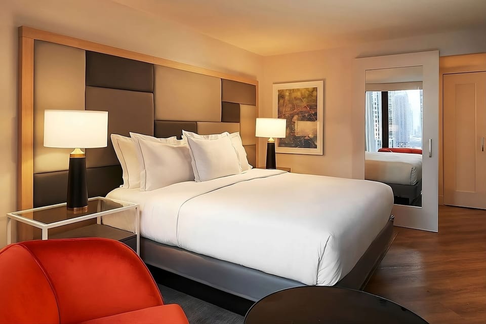 Sink into crisp linens under warm, restful ambient lighting.