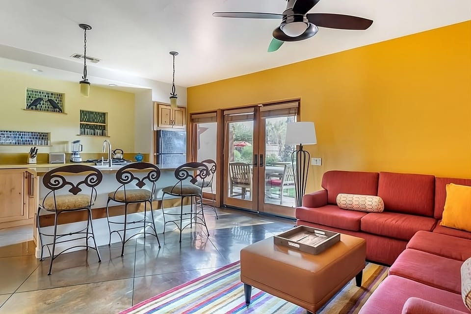 Gather in the sunlit living room with patio doors.
