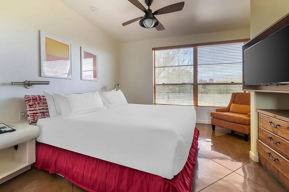 Relax into crisp linens in this sunny, quiet bedroom.