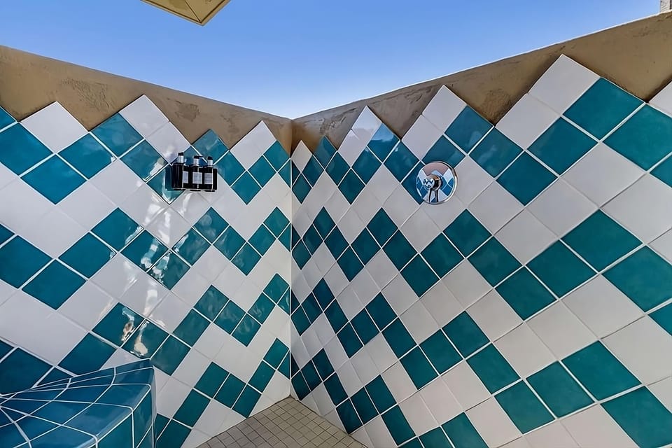 Rinse off under open sky in a bold tiled shower.