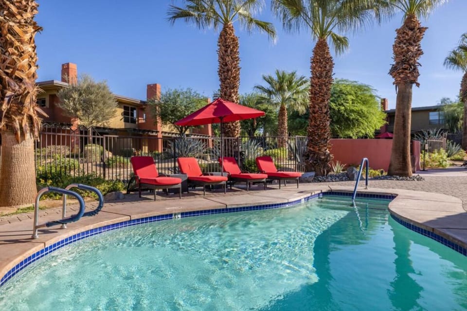 Cool off in a quiet corner pool framed by palms.