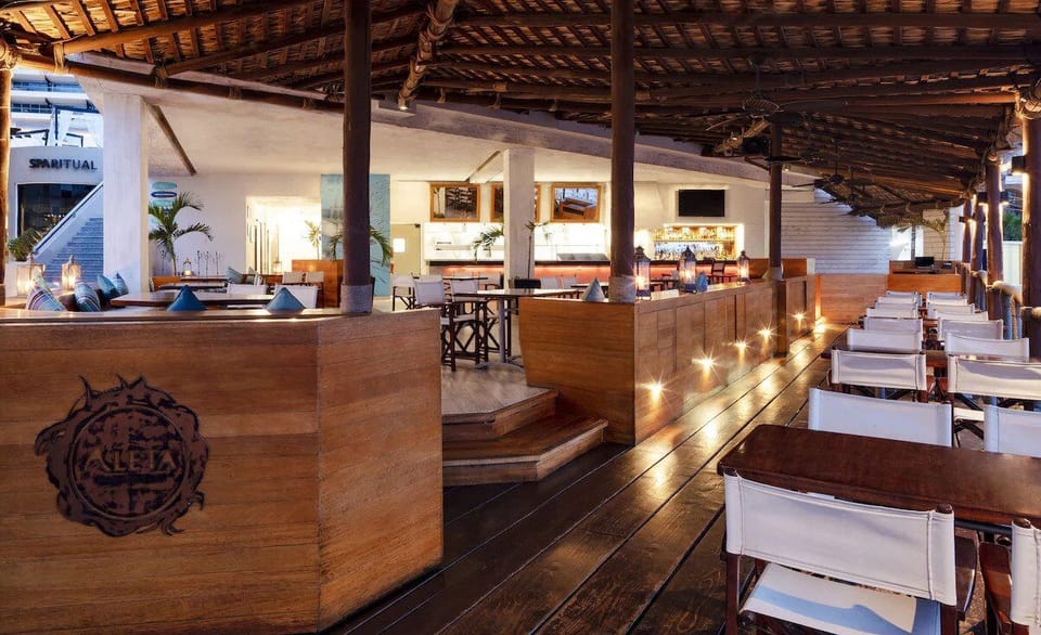 Dine alfresco under warm lights with a lively resort vibe.