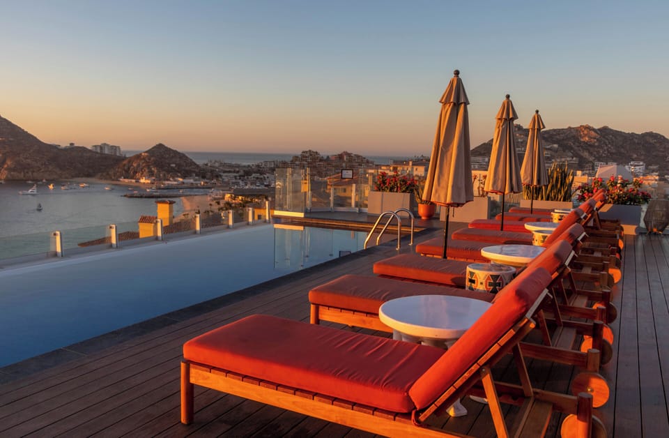 Unwind at sunset beside the rooftop infinity pool loungers