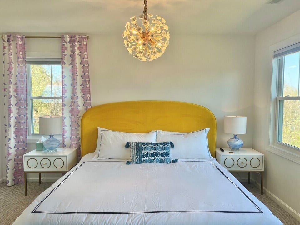 Primary bedroom features brand new King bed, picture window view of mountains (not shown here), 50” mounted flat screen smart tv, small walk-in closet and full en suite bath with tiled tub shower 