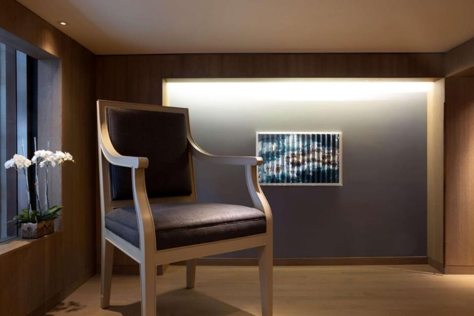 Unwind in a quiet nook with warm, sculpted lighting.