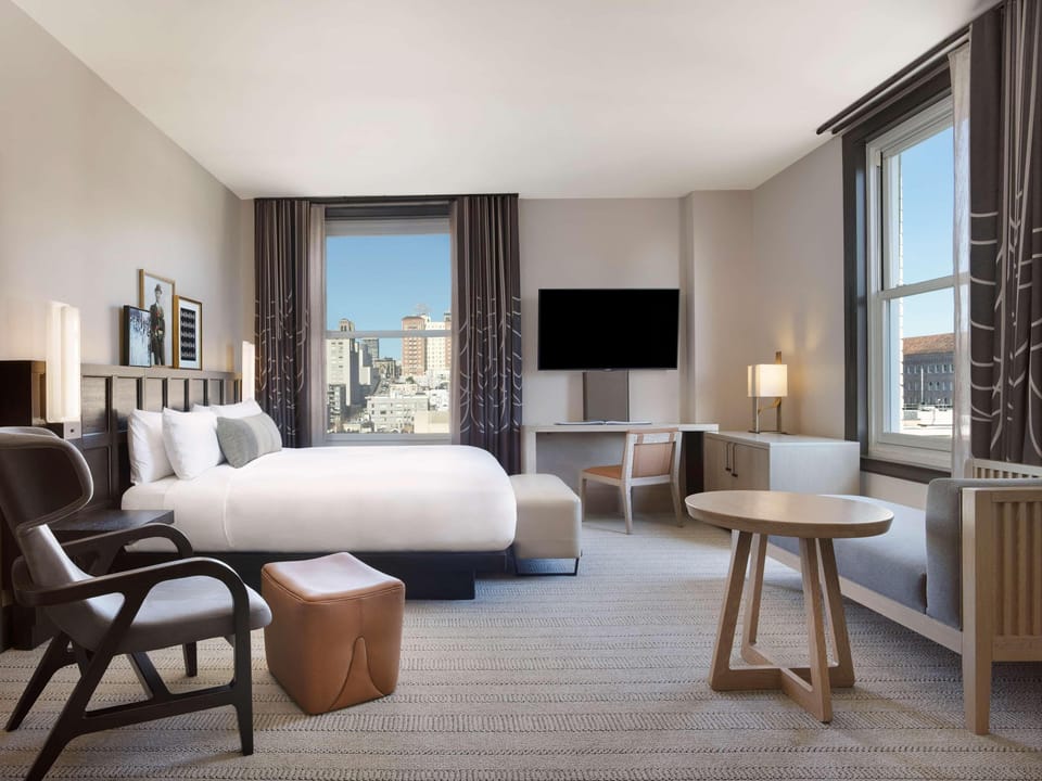 Wake up to skyline views in a bright, airy king room.