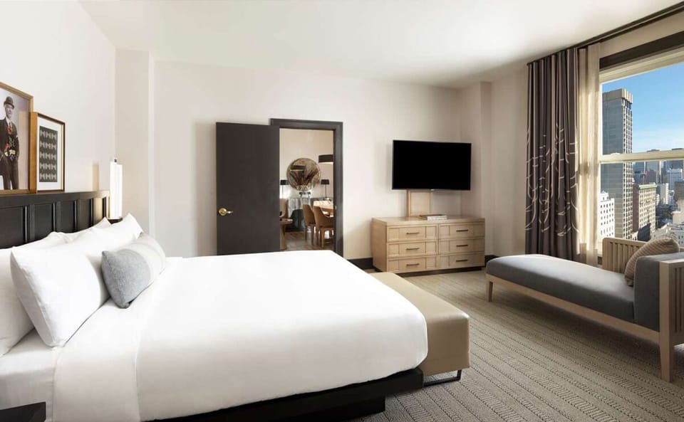 Unwind in crisp linens with skyline views and quiet comfort.