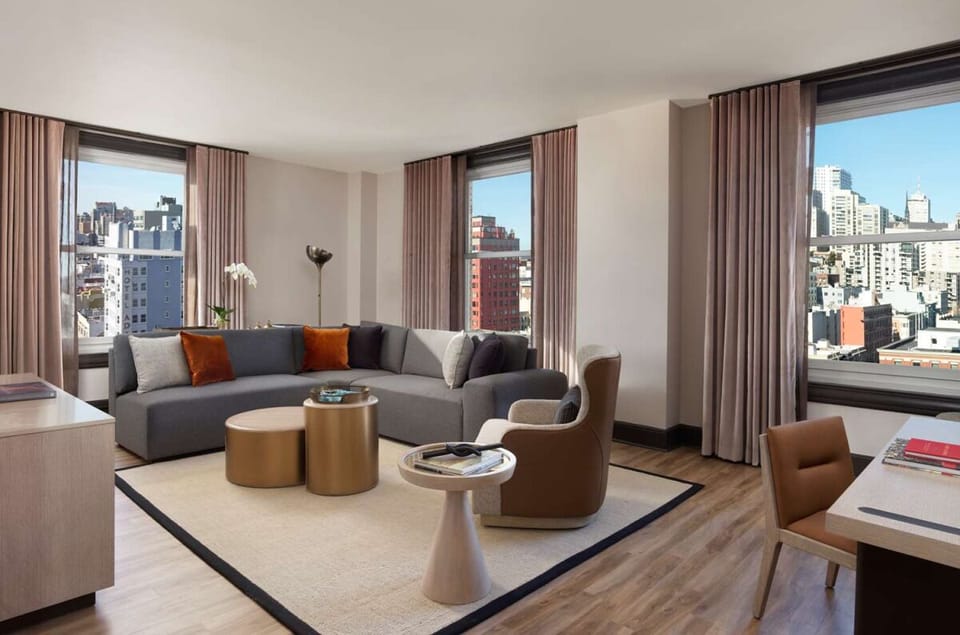 Relax on the roomy sectional beside sunlit corner windows.