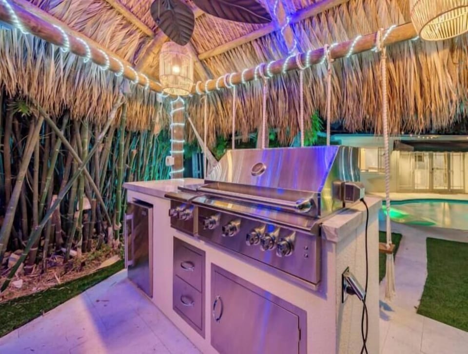 Outdoor tiki hut with built in kitchen BBQ & Outdoor Dining Table
Heated Pool & Lush fenced private back yard with water features, artificial turf, hammock, swings and Talum feel. 