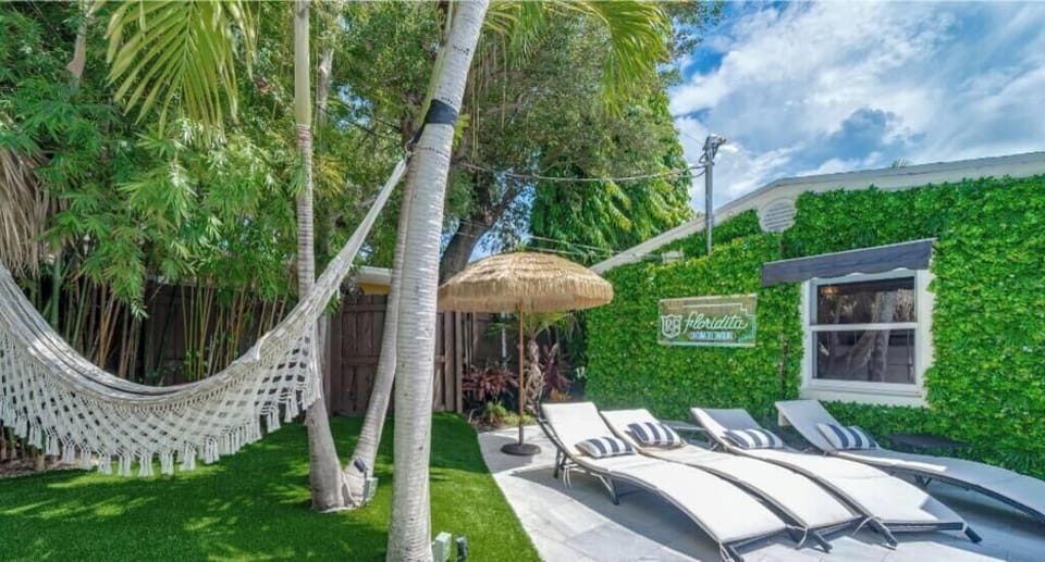 Outdoor tiki hut with built in kitchen BBQ & Outdoor Dining Table
Heated Pool & Lush fenced private back yard with water features, artificial turf, hammock, swings and Talum feel. 