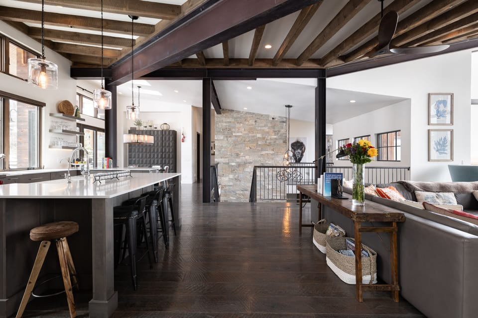 - Spacious open floor plan with rustic wood beams  
- Gourmet kitchen and long island perfect for gatherings  
- Modern design blends with stone walls and natural light