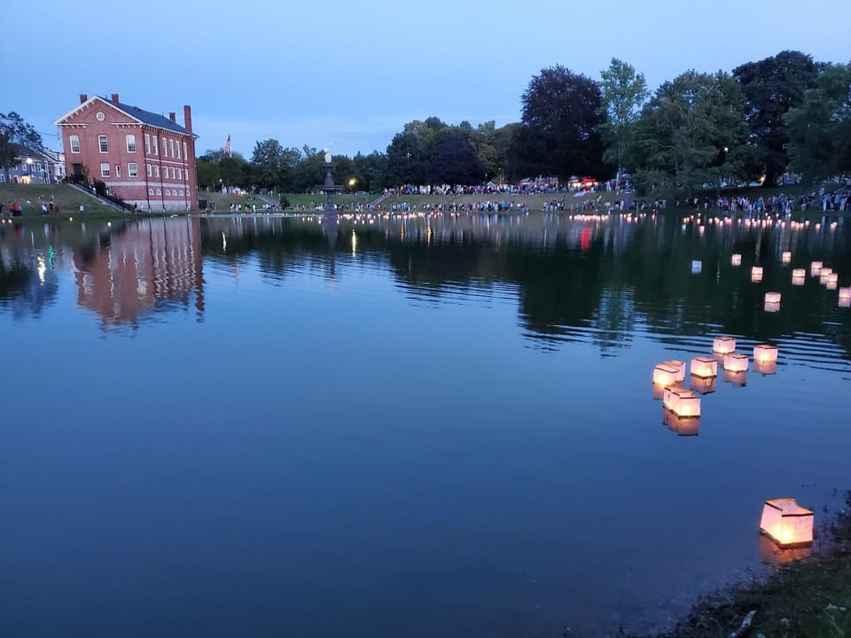 Frog Pond Lantern Festival at dusk across the street.