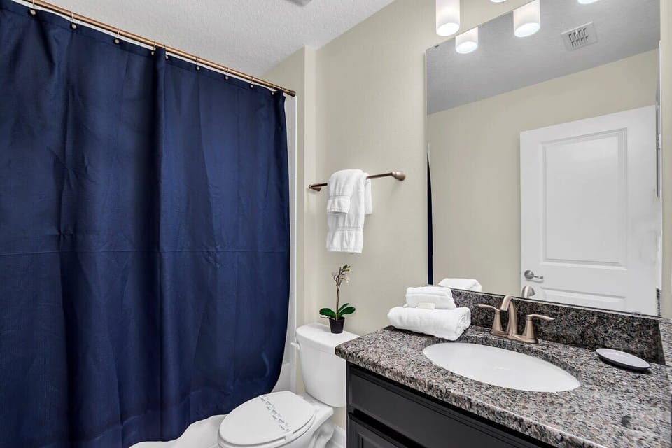 Refresh and recharge in this beautifully appointed full bathroom featuring a spacious single vanity, shower, bright lighting, and stylish finishes for an elevated start and end to your day.