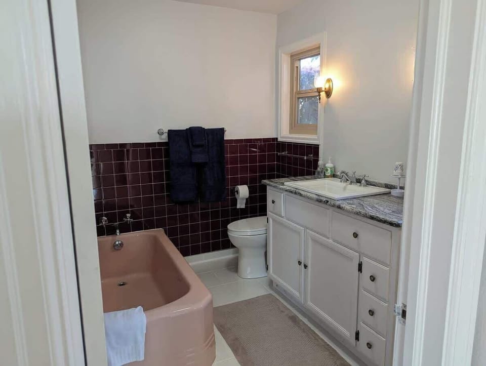 Your private has a 1950 pink bathtub and a separate shower.