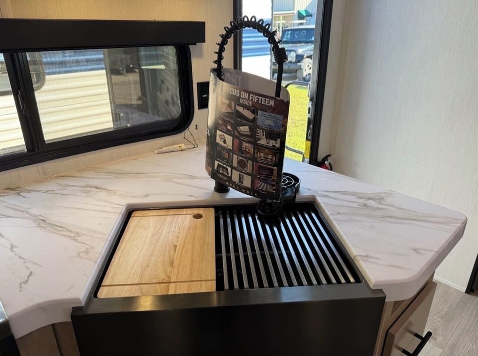 Pull down faucet, movable cutting board & drain rack, cup washer and deep sink.