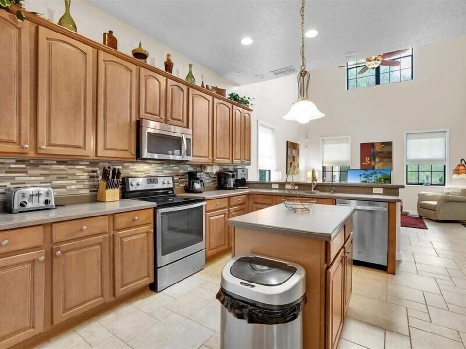 Spacious kitchen with modern appliances, an island, and elegant cabinetry.