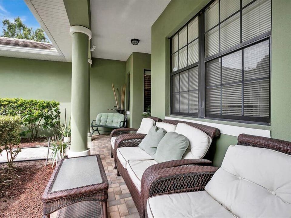 Cozy covered patio with comfortable seating for outdoor relaxation.