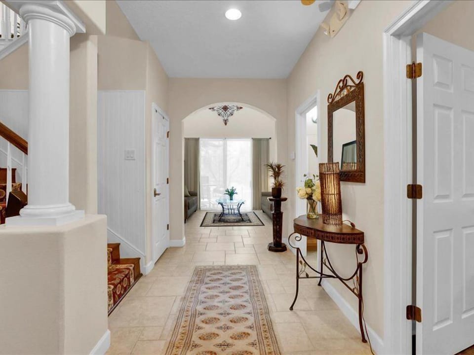 Grand foyer entrance with stylish decor and natural light.