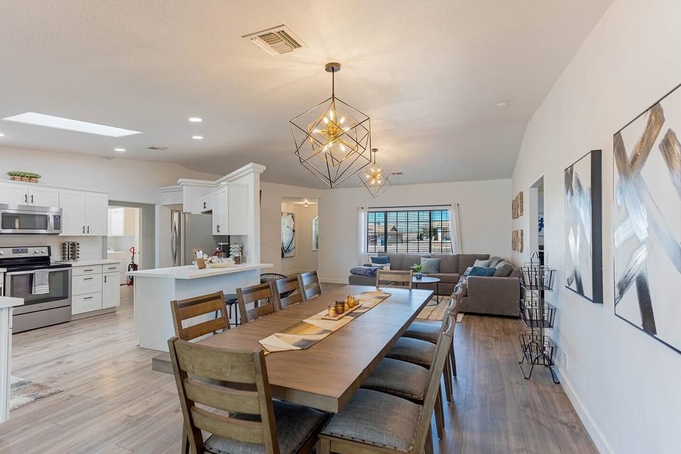 Open concept means everyone's in the conversation — kitchen, dining, and living all connected so the group never splits up unless they want to.
