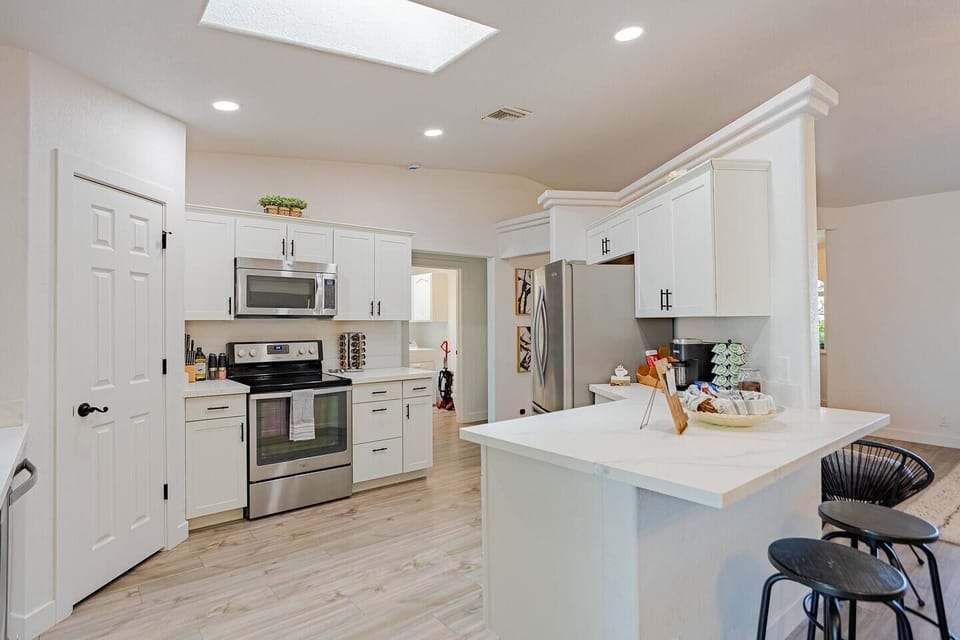 Your kitchen has the real setup — stainless oven, quartz counters, and enough storage that you never have to dig for anything mid-recipe.