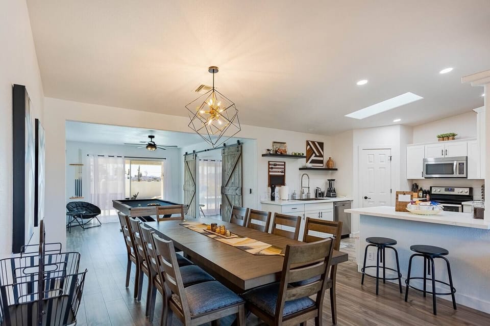 Pull the whole group around the dining table — seats 10 with the drop-in leaf in, and the kitchen's right there so food hits the table hot.