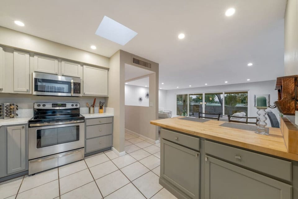 Updated, fully-equipped kitchen leads into grand living room