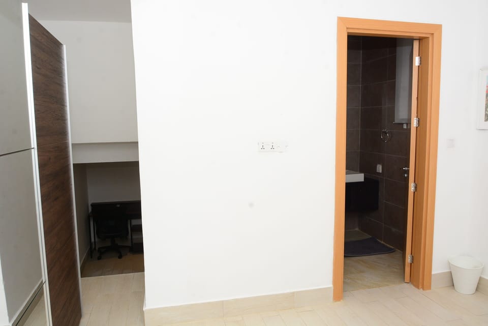 Master bedroom wardrobe and step down to Den with workspace.